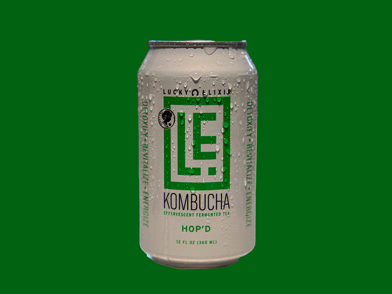 A can of Lucky's Elixir Kombucha with 'HOP'D' written on it, set against a green background.