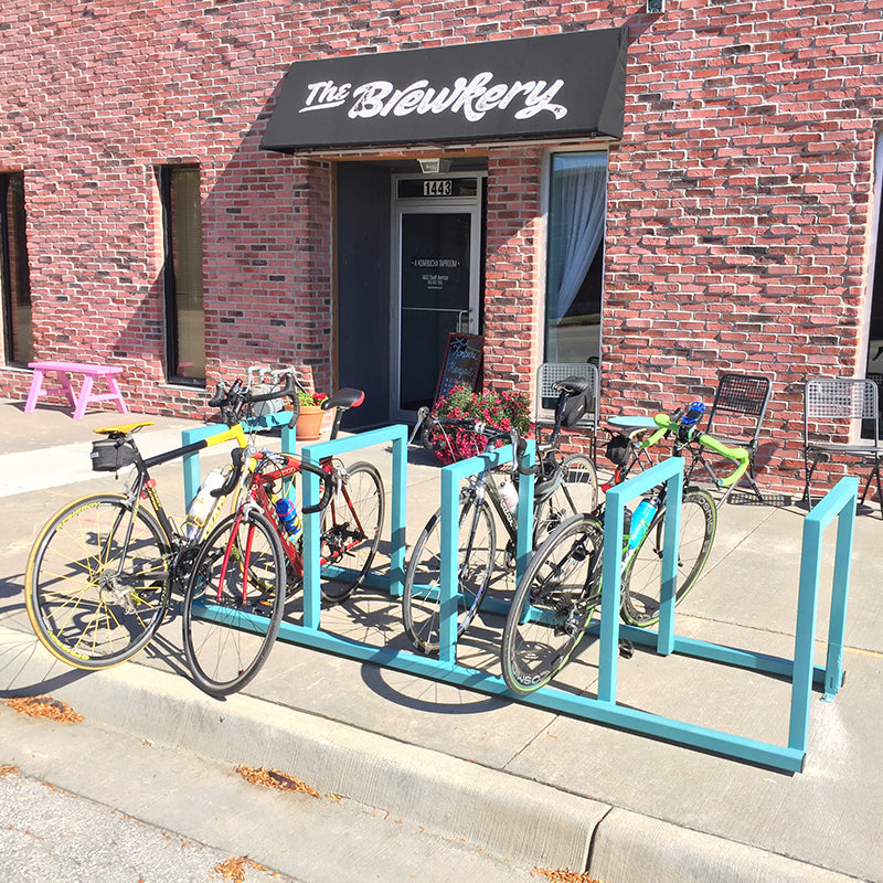 Bicycle rack outside a building with 'The Brewkery' sign.
