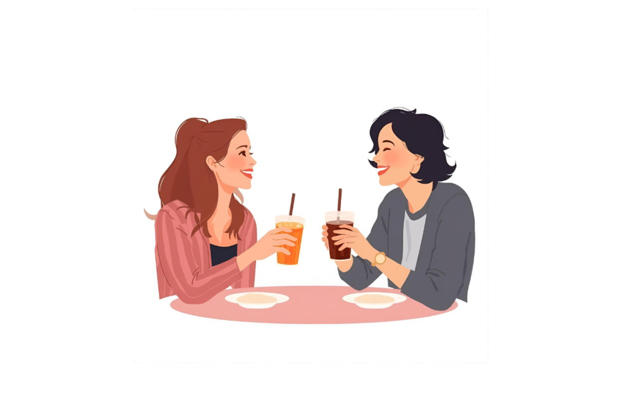 Two women sitting at a table with drinks, smiling and talking.